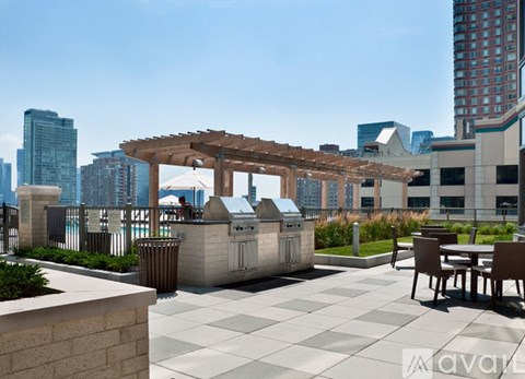 A patio with a table and chairs and a grill.