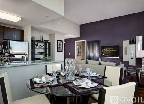 A modern dining room with a glass table set for six.