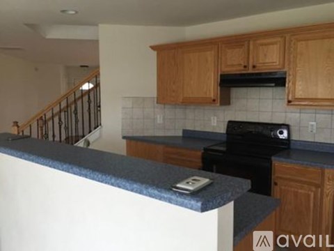 A kitchen with wooden cabinets and a black stove top oven.
