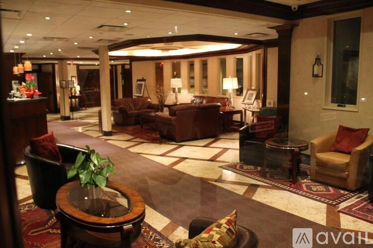 A large, well-lit room with a variety of seating options and a carpeted floor.