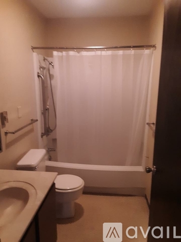 A bathroom with a toilet, sink, and shower.