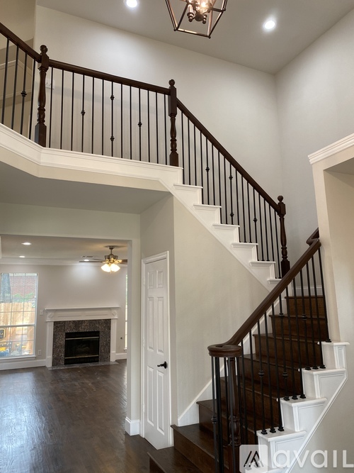 A large open space with a staircase leading to the second floor.