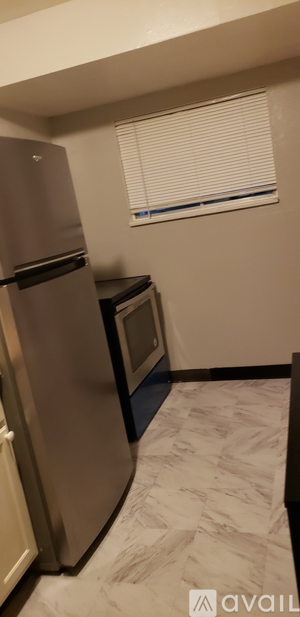 A kitchen with a refrigerator and a microwave.