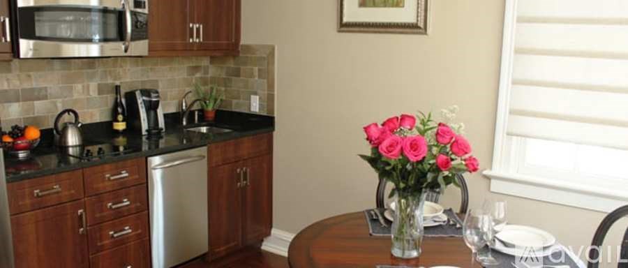 A kitchen with a dishwasher, microwave, and sink.