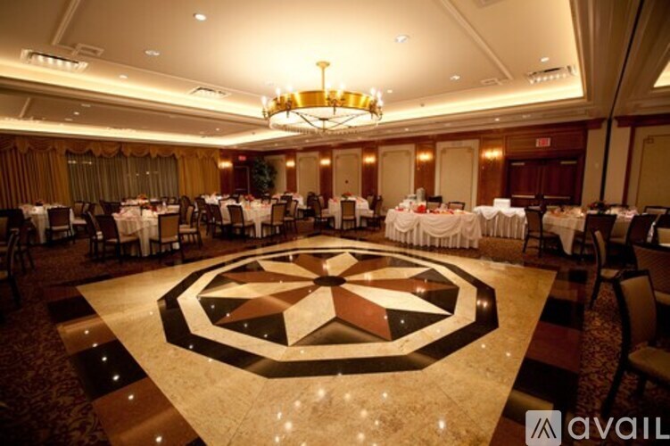 A large, well-lit ballroom with tables set up for an event.