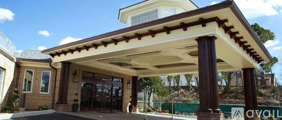 A house with a covered entrance and a balcony.