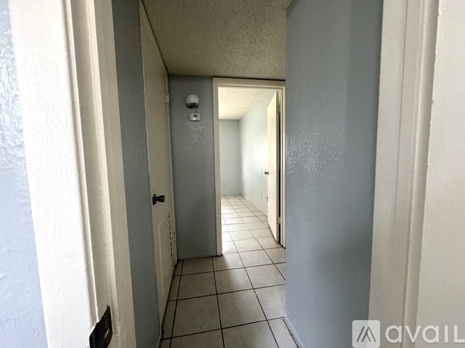 A hallway with a door at the end.