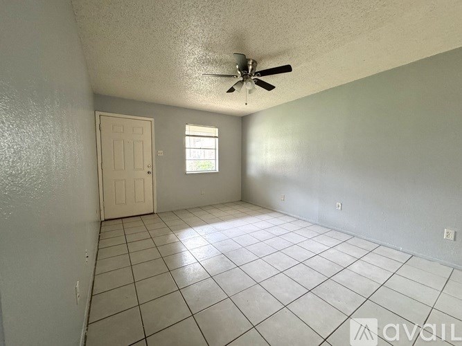 A room with a ceiling fan and a window.