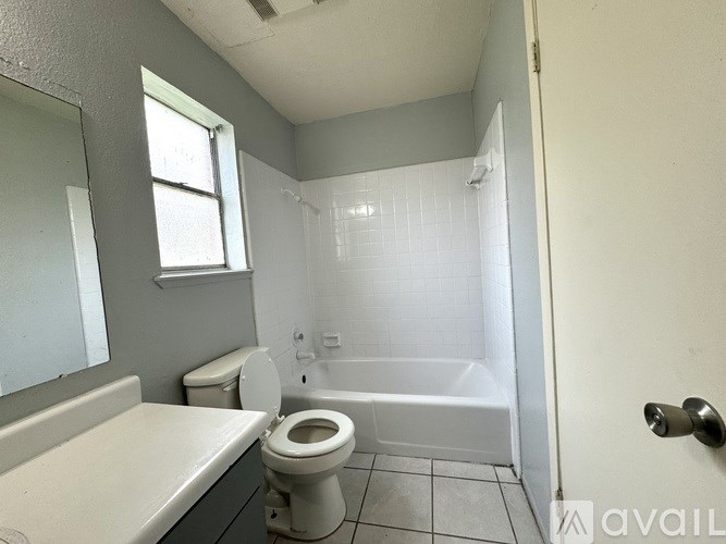 A bathroom with a toilet, sink, and bathtub.