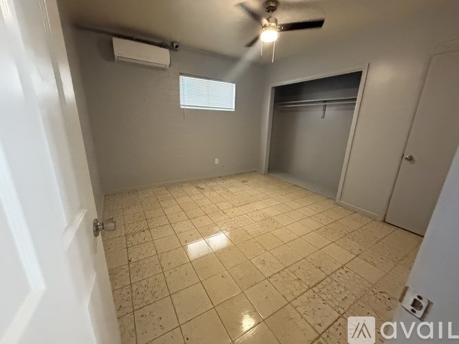 A room with a tiled floor and a ceiling fan.