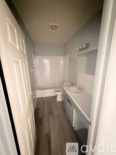 A kitchen with a refrigerator, oven, and microwave.
