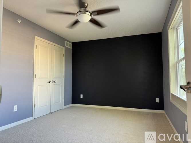 A white bathtub with a silver faucet and a wall-mounted shower head.