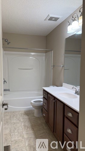 A room with a ceiling fan and a door.