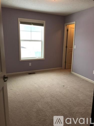 A room with purple walls and a window.