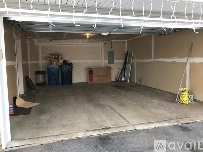 A garage with a white roof and a concrete floor.