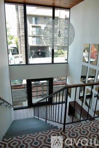 A view of a staircase from the top floor of a building.