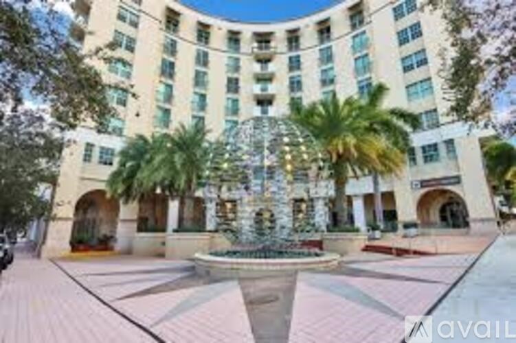 A large building with a fountain in front of it.