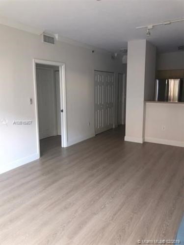 A room with a wooden floor and white walls.