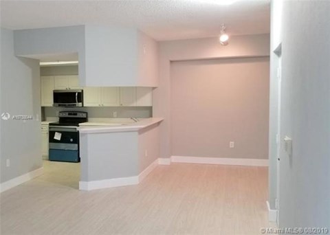 A kitchen area with a microwave, oven, and dishwasher.