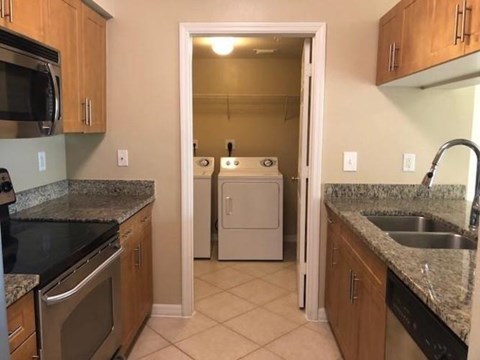 A kitchen with a white dishwasher and a microwave.