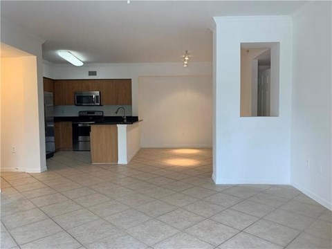 A kitchen area with a microwave and a countertop.