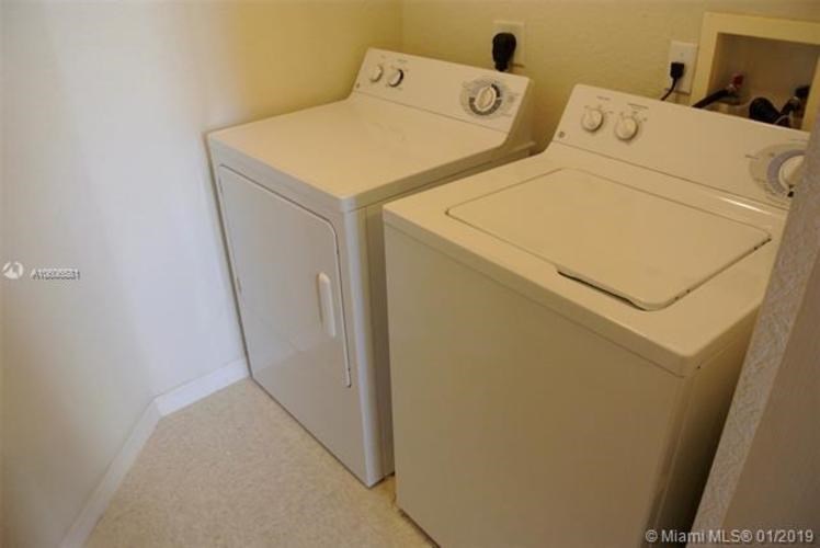 A white washer and dryer in a small room.