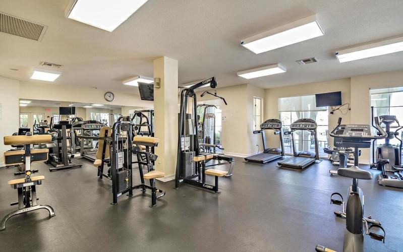 A spacious gym with a variety of equipment including treadmills, weights, and exercise machines.