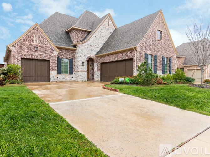 A large house with a driveway in front.