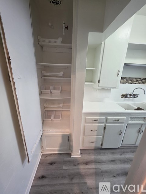 A kitchen with white cabinets and a countertop.