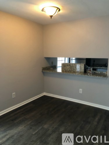 A room with wooden flooring and a window.