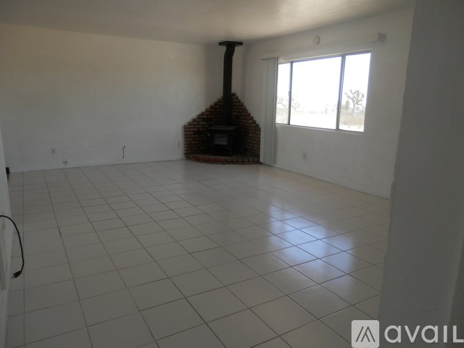 A room with a fireplace and tiled flooring.