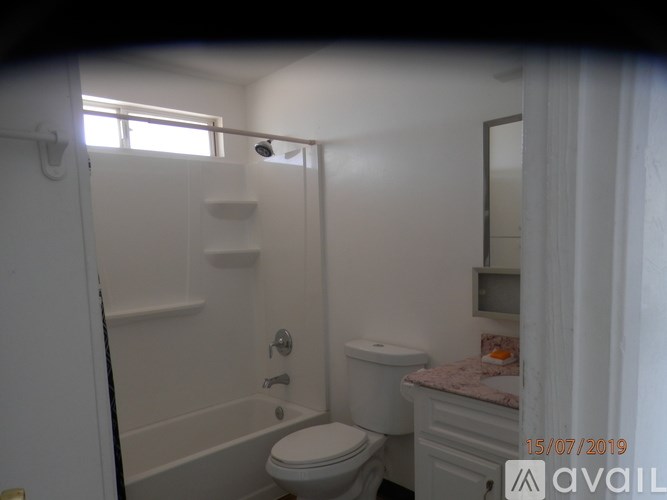 A bathroom with a toilet, sink, and bathtub.