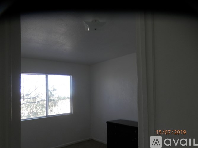 A room with a window and a ceiling fan.