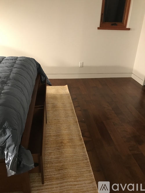 A bedroom with a bed and a window.