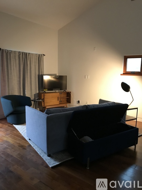 A living room with a grey couch and a television.