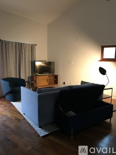 A living room with a grey couch and a television.