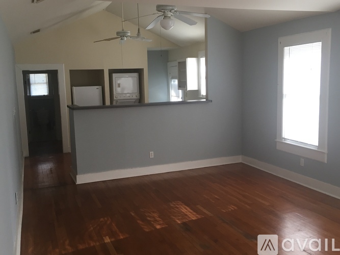 A room with wood floors and a ceiling fan.