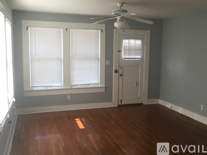 A room with a wooden floor and a ceiling fan.