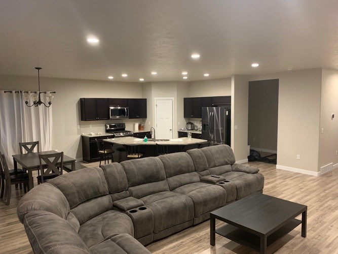 A grey sectional sofa with a coffee table in front of it.