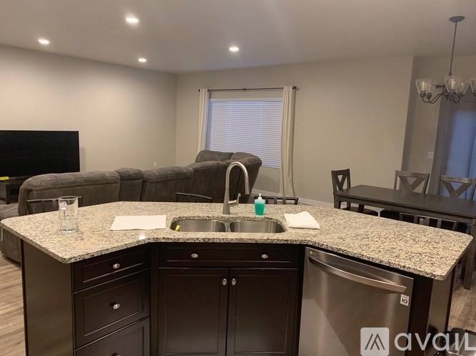 A kitchen with granite countertops and a stainless steel sink.