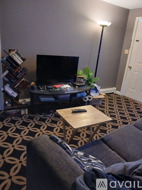 A white refrigerator and oven are in a room with a patterned carpet.