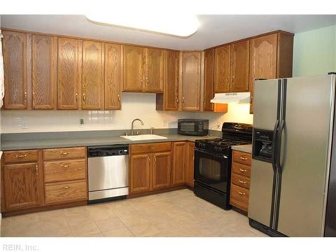 A kitchen with wooden cabinets and stainless steel appliances.