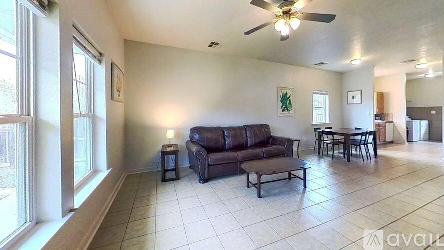 A long hallway with a door on the left and a window on the right.