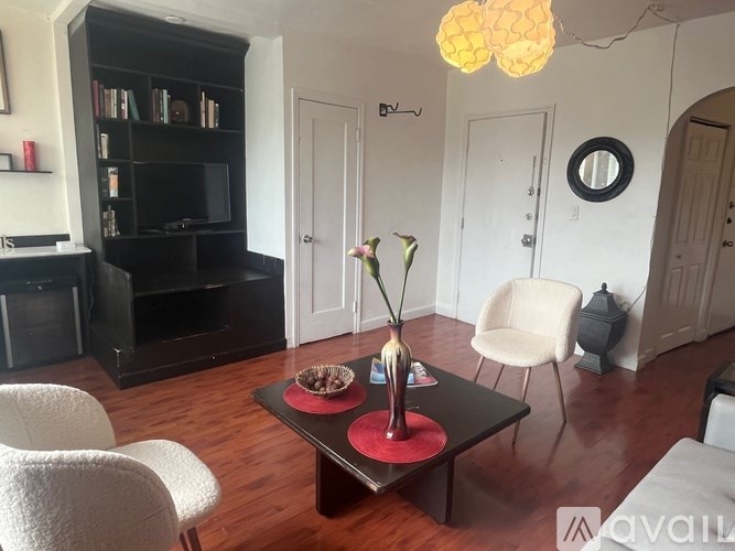 A living room with a black coffee table and a white chair.