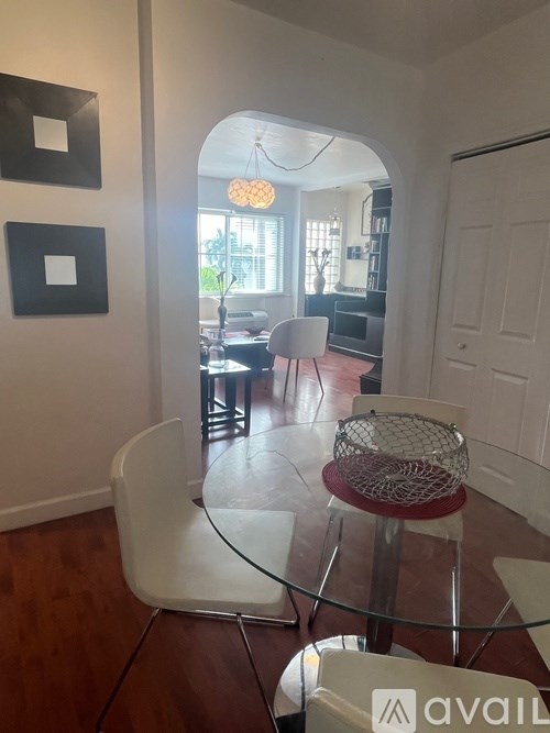 A living room with a glass table and chairs.
