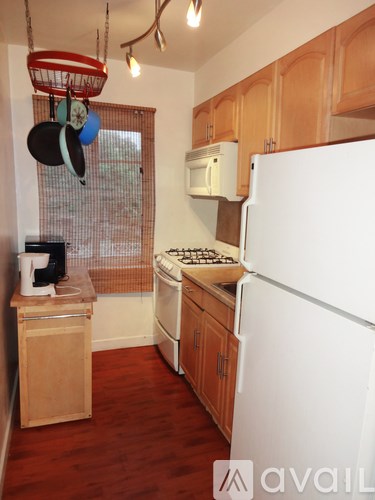 A kitchen with wooden cabinets and a white refrigerator.