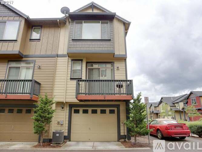A two-story apartment building with a balcony on the second floor.