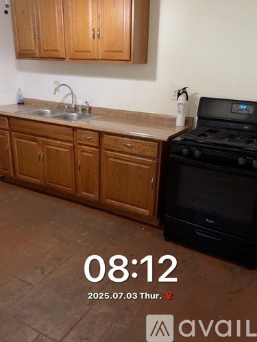 A room with a ceiling fan and wood flooring.