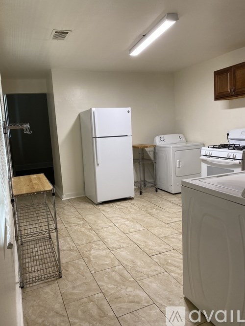 A kitchen with a white fridge, a white stove, and a white dishwasher.