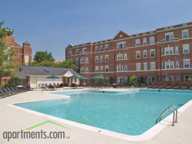 Apartments.com advertises a swimming pool at a brick apartment complex.